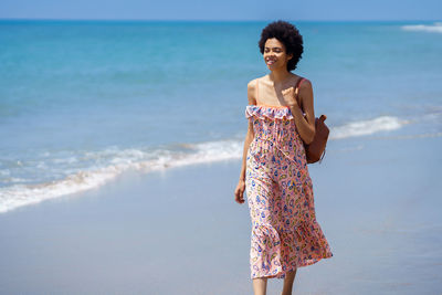 Young woman walking on beach