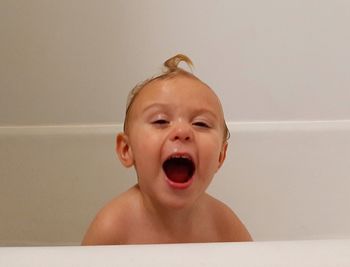 Portrait of cute baby boy in bathroom