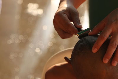 Close-up of hands shaving head