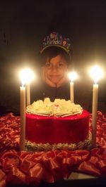 Portrait of man with lit candles on birthday cake