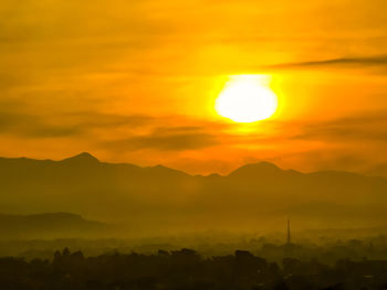 Scenic view of silhouette mountains against romantic sky at sunrise