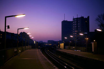Illuminated road against sky at night