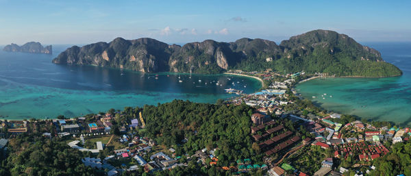 High angle view of townscape by sea against sky