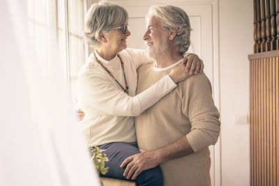 Rear view of man and woman sitting at home