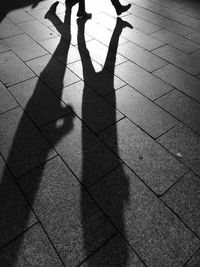 Shadow of people on footpath