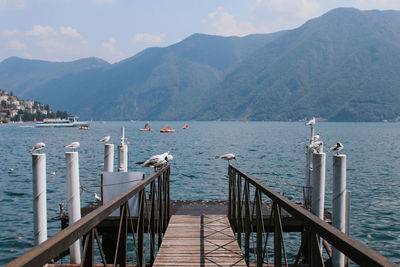 Pier over sea against mountain