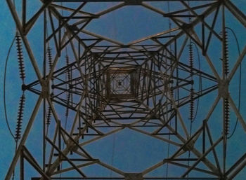 Low angle view of electricity pylon against sky