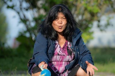 Mid adult woman sitting outdoors