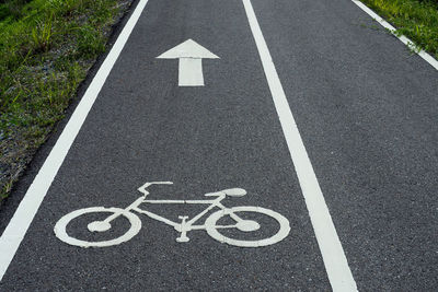 High angle view of arrow symbol on road