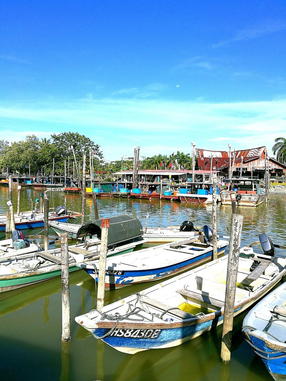 transportation, mode of transport, nautical vessel, water, high angle view, boat, moored, blue, city, sky, building exterior, river, harbor, in a row, day, outdoors, tourism, waterfront, city life, cloud - sky, no people, sea, scenics, famous place, development