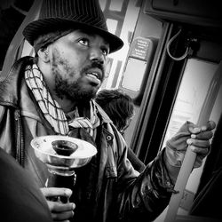 Portrait of young man sitting in bus