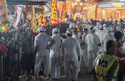 Crowd on street in front of market