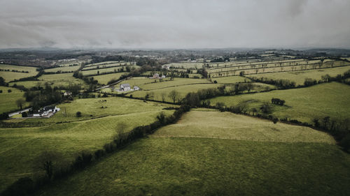 Scenic view of agricultural landscape against sky