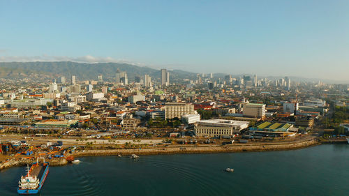 High angle view of river and buildings against clear sky