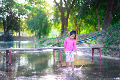 Smiling girl playing in water
