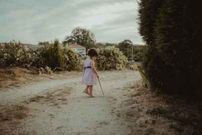 Girl walking on dirt road