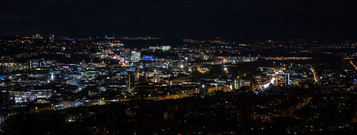 High angle view of illuminated city buildings at night