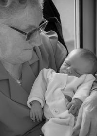 Close-up of grandmother holding baby girl