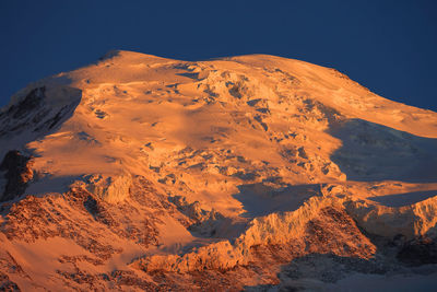 Scenic view of snowcapped mountain during sunset