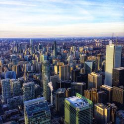 Aerial view of modern buildings in city against sky