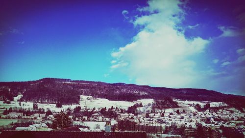 Scenic view of mountains against cloudy sky