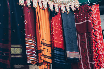 Multi colored flags hanging in a row for sale at market stall