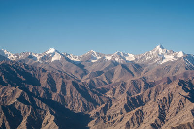 Scenic view of mountains against clear blue sky