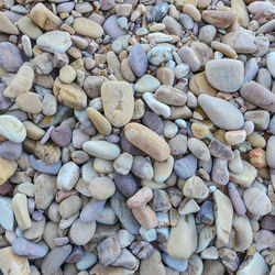 Close up of rounded and polished beach rocks on the sea shore