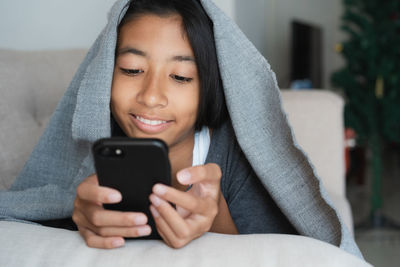 Portrait of young woman using mobile phone