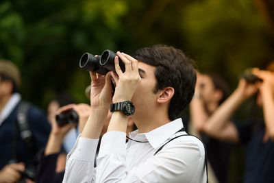 Portrait of teenage girl holding camera