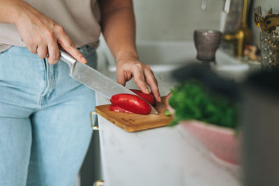 Midsection of man preparing food in kitchen at home