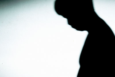 Close-up of silhouette hand against white background