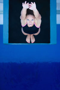 High angle view of woman diving into swimming pool