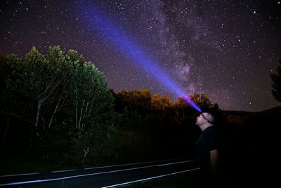 Silhouette of people standing at night