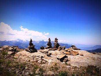 Scenic view of mountains against blue sky