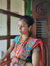 Young woman looking away at home