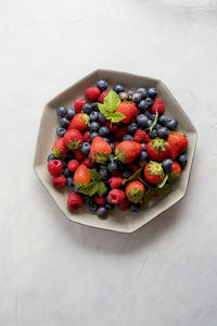 High angle view of strawberries in bowl on table