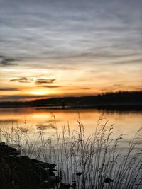 Scenic view of lake against sky during sunset