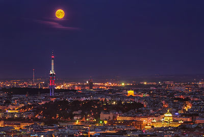 Illuminated cityscape against sky at night