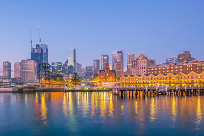 Reflection of buildings in city at waterfront