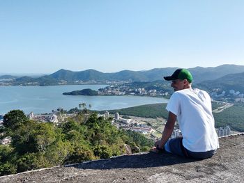 Man on mountain against clear sky