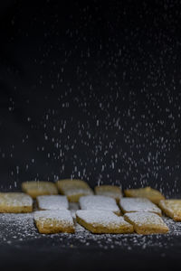 Close-up of food on table against black background