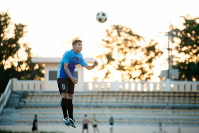 Full length of young man playing soccer