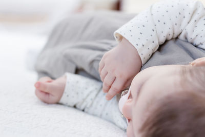 Close-up of baby sleeping at bed