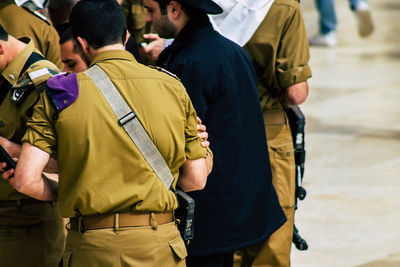 Rear view of people standing on street