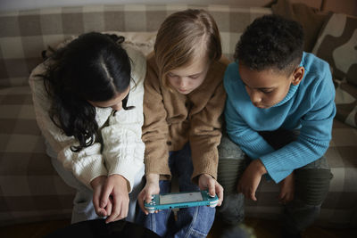 Children playing video games at home