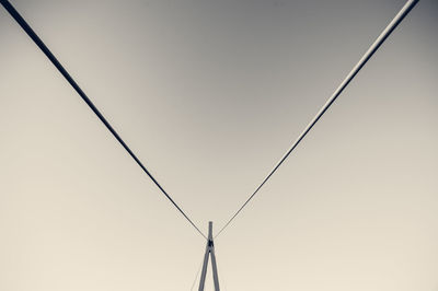 Low angle view of cables against clear sky