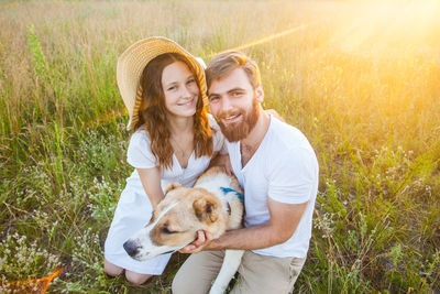 Portrait of happy young couple against plants