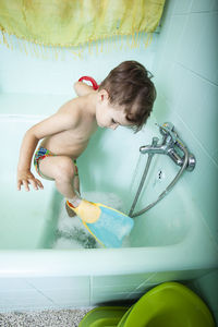 Full length of shirtless boy in bathroom at home