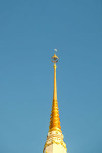 Low angle view of bell tower against blue sky
